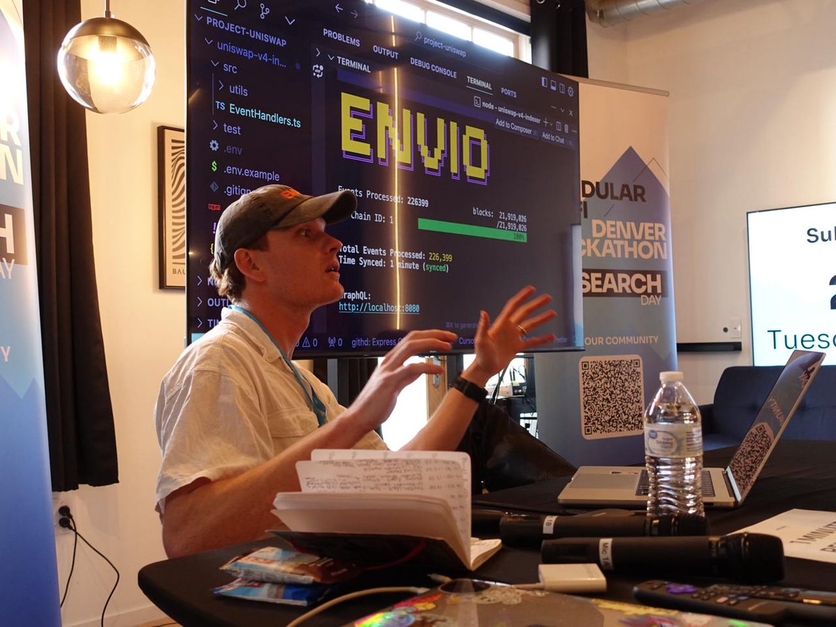 Jonjon presenting at the Encode Club Modular DeFi Hackathon with the Envio Uniswap v4 indexer running on a screen behind him